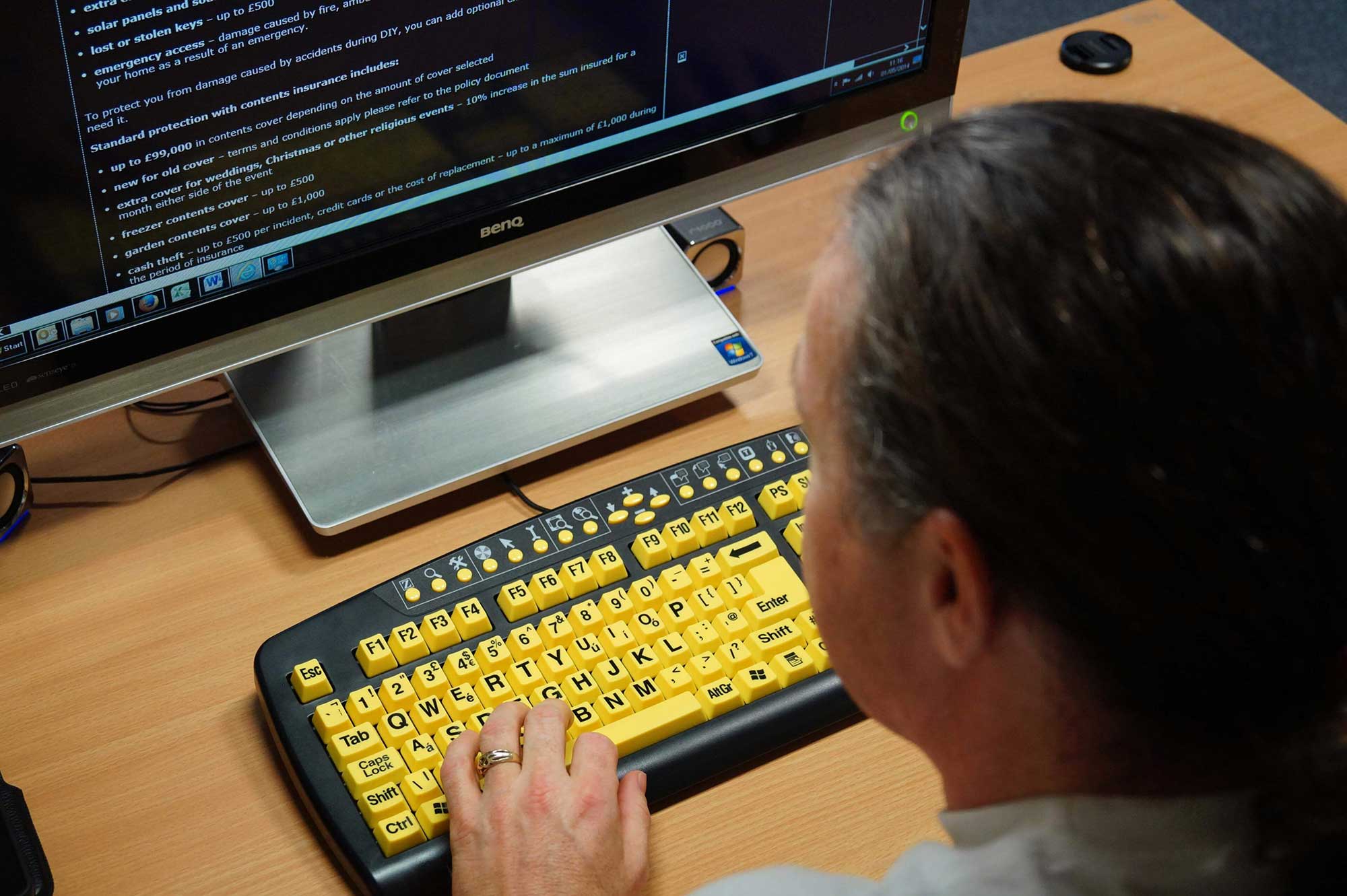 DAC Staff member using high visiblity Keyboard.